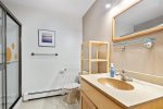 Full bathroom in the hallway with large walk in shower 